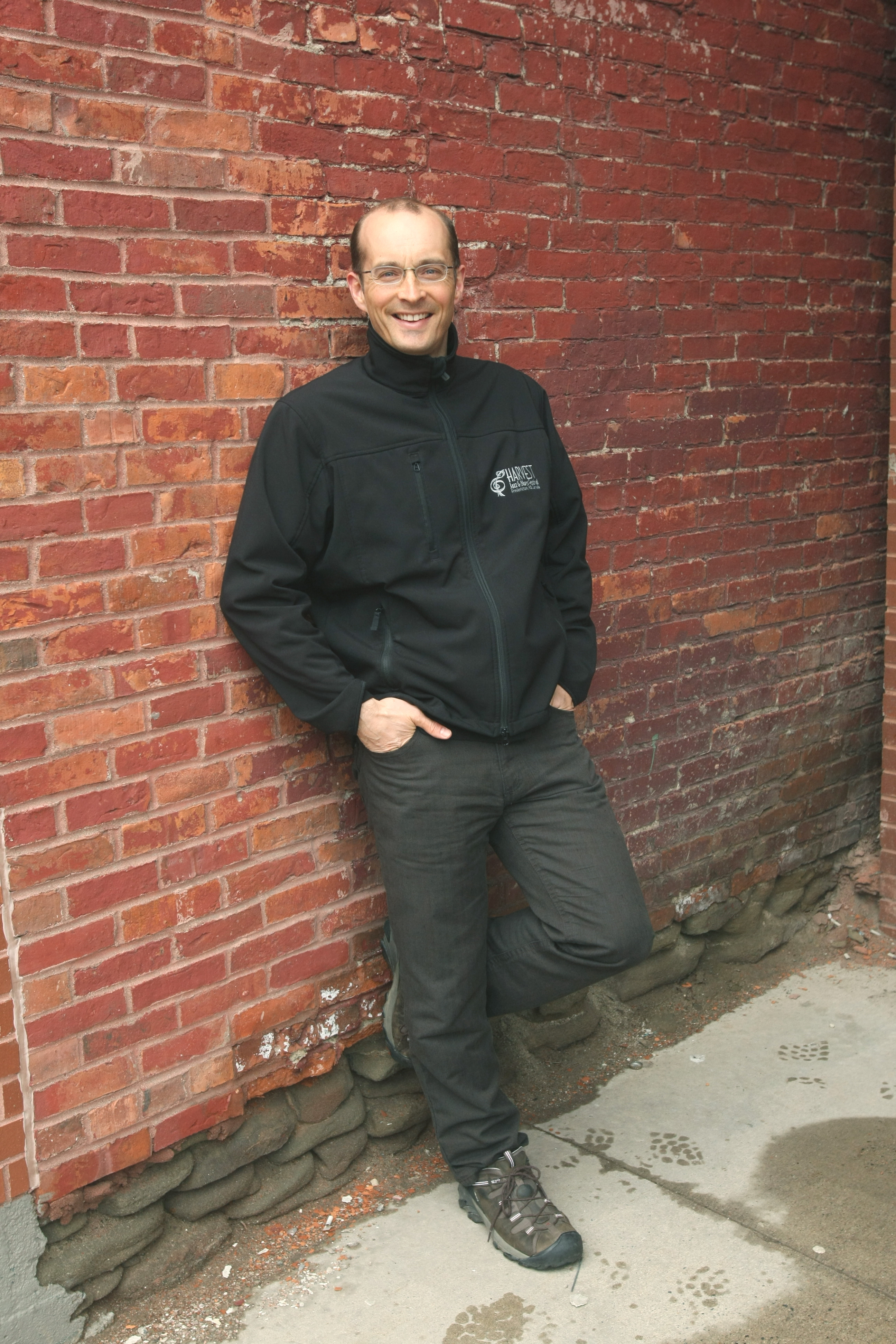 Brent Staeben standing in front of a brick wall