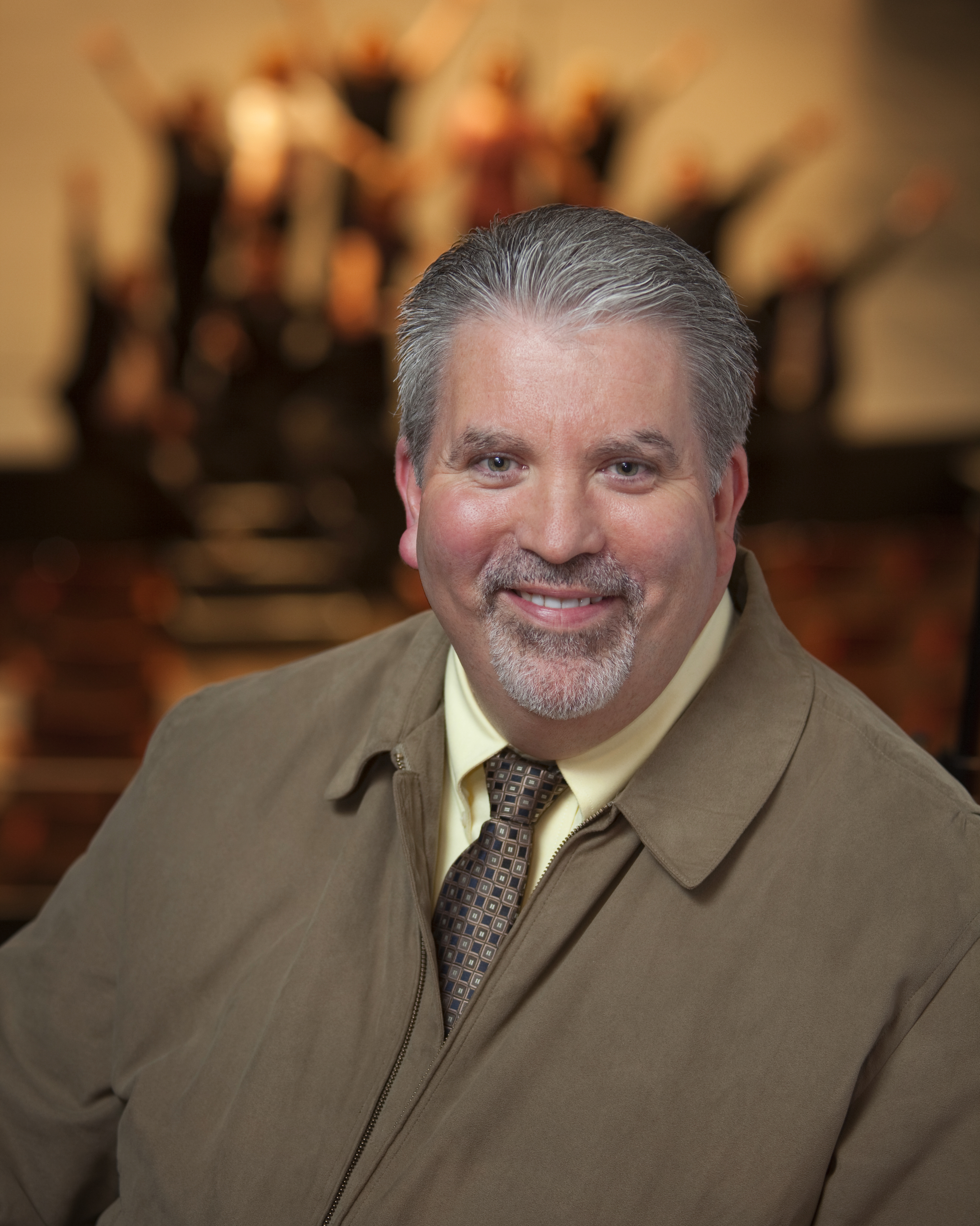 Headshot of Philip Sexsmith wearing a light brown jacket