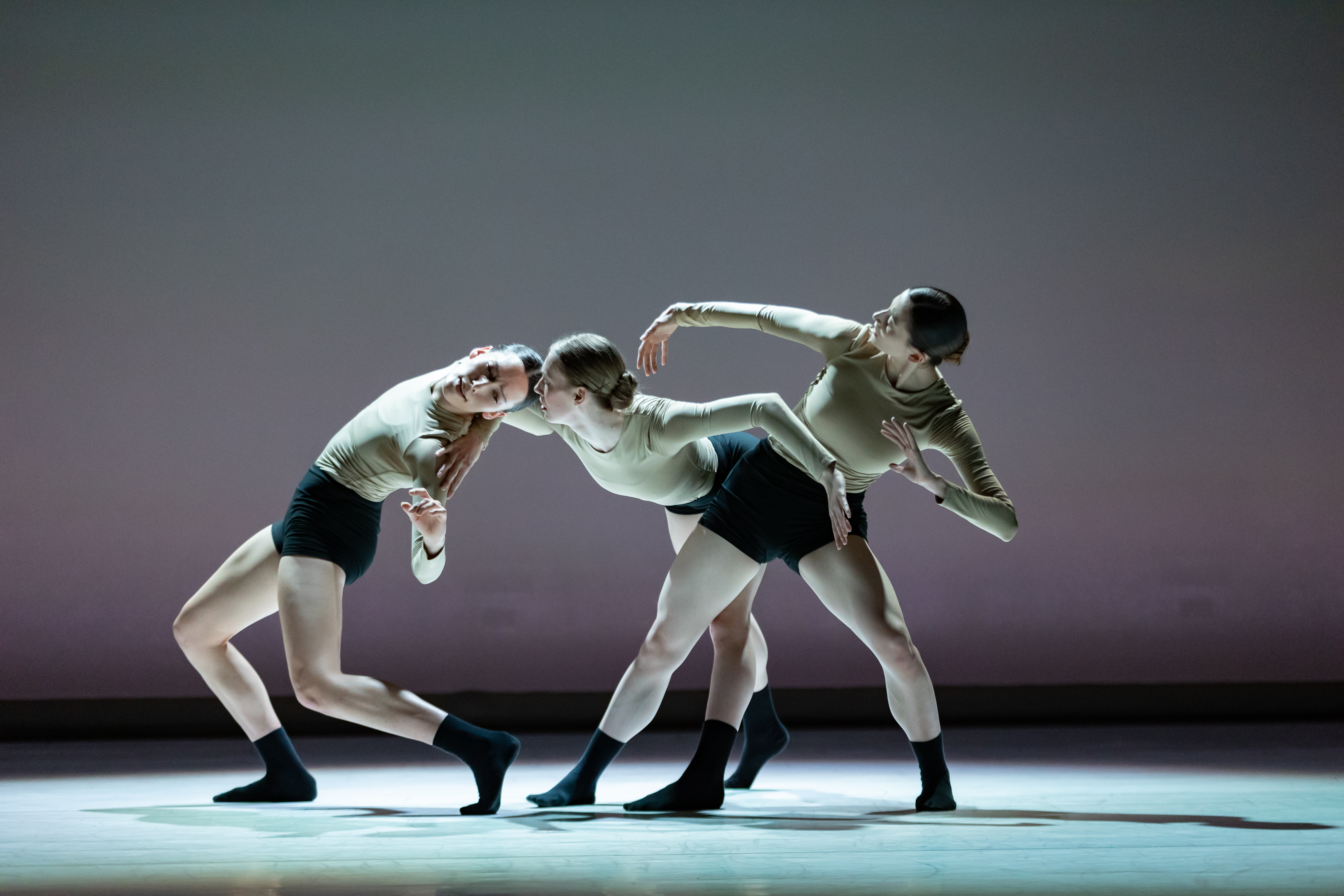 Three Ballet Edmonton dancers are dancing and creating a formation