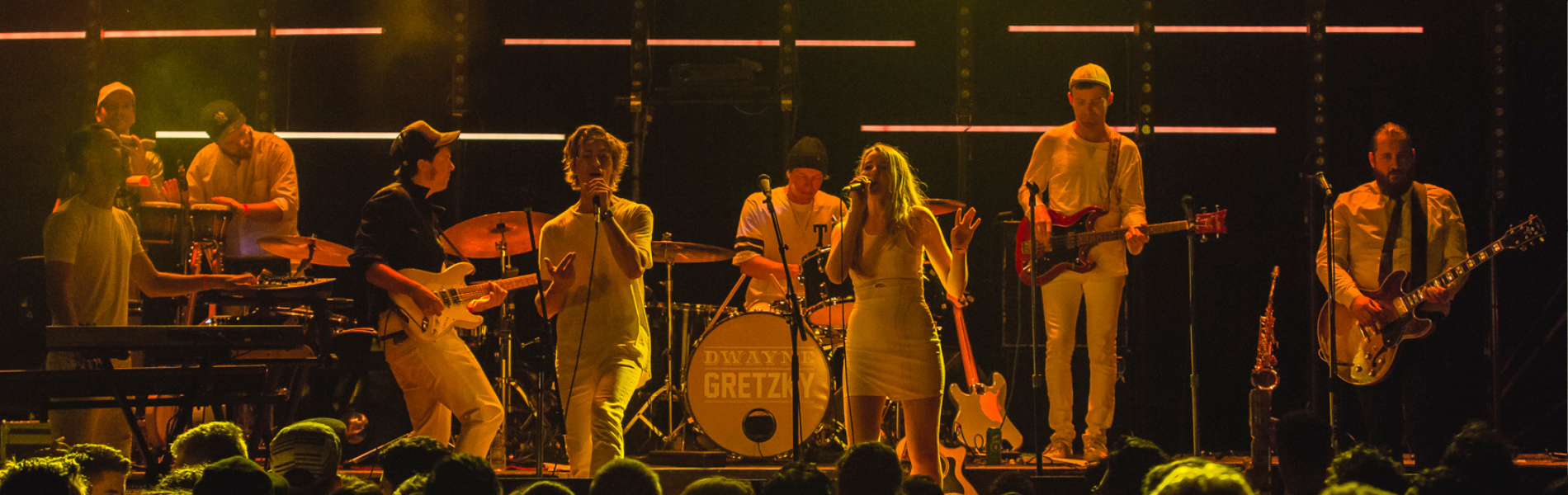Eight members of Dwayne Gretzky on stage in low lighting