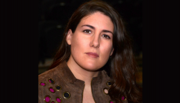 Headshot of Tania Breen against a dark background