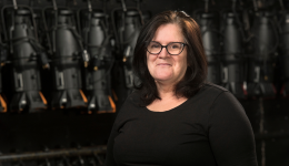 Bonnie Barlow in a black shirt against a black stage backdrop