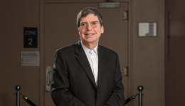 Wylie Casey standing in front of a closed theatre door