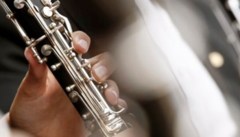 Hands holding wind instruments.