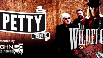 A group of men standing against a wood background with the words Tom Petty and Wildflowers.