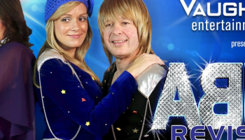 Two couples dressed up as ABBA members with the words ABBA Revisited in sparkling silver letters.