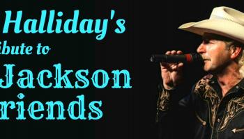 A side view of Aaron Halliday as Alan Jackson singing into a mic, with a black background.