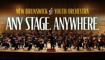The NBYO on stage. The words Any Stage. Anywhere in bold white lettering above them.