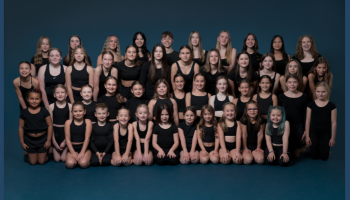 X-treme Dance company photo over a dark blue background. 