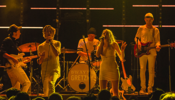 Eight members of Dwayne Gretzky on stage in low lighting
