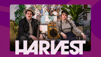 The two artists from Blue Moon Marquee lounge in chairs with plants behind them. The word HARVEST below their photo.