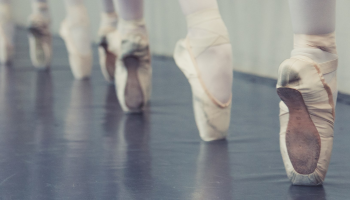 An image of Ballerinas feet on pointe.