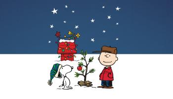 Charlie Brown and Snoopy stand outside on a snowy day.