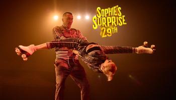 Two acrobats hold each other in a fun pose.