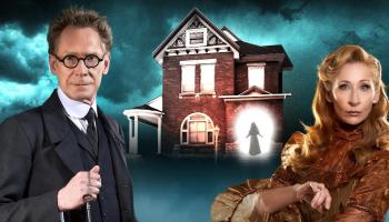 Two magicians stand in front of a mysterious house. 