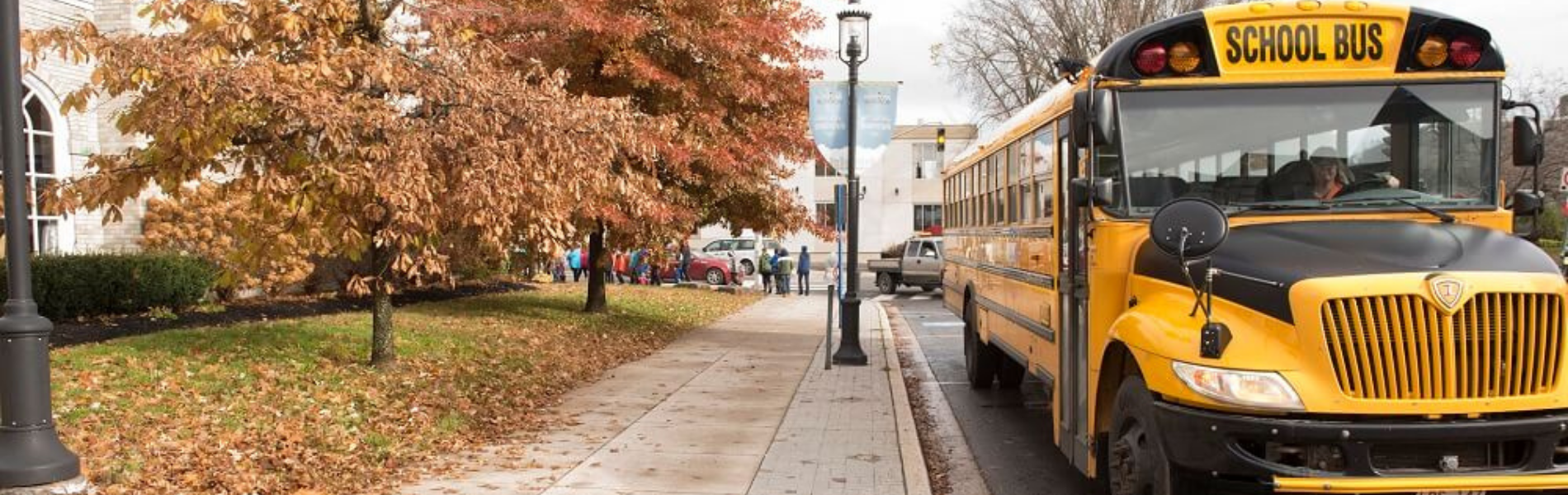 A school bus parked on the road next to the Playhouse