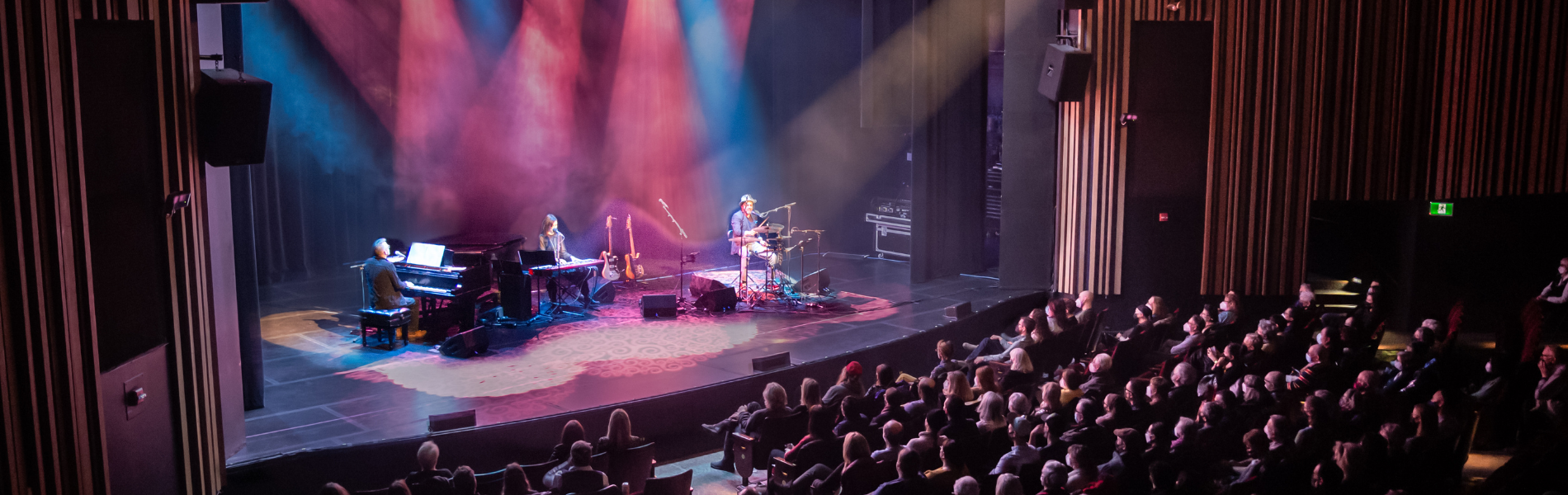 A full audience in the Playhouse with a band on stage