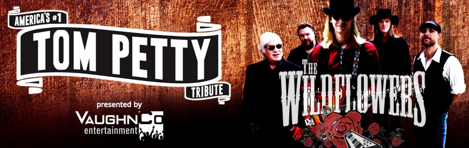 A group of men standing against a wood background with the words Tom Petty and Wildflowers.