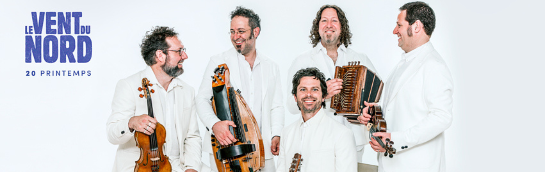 5 members of Vent du Nord dressed in white against a white background each holding instruments