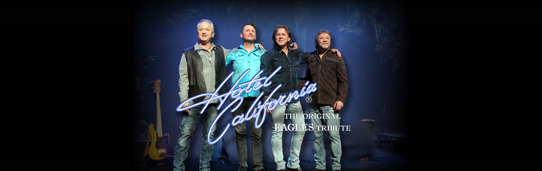 Four artists on stage with their instruments behind them. The words, 'Hotel California The Original Eagles Tribute' over the middle of the image.