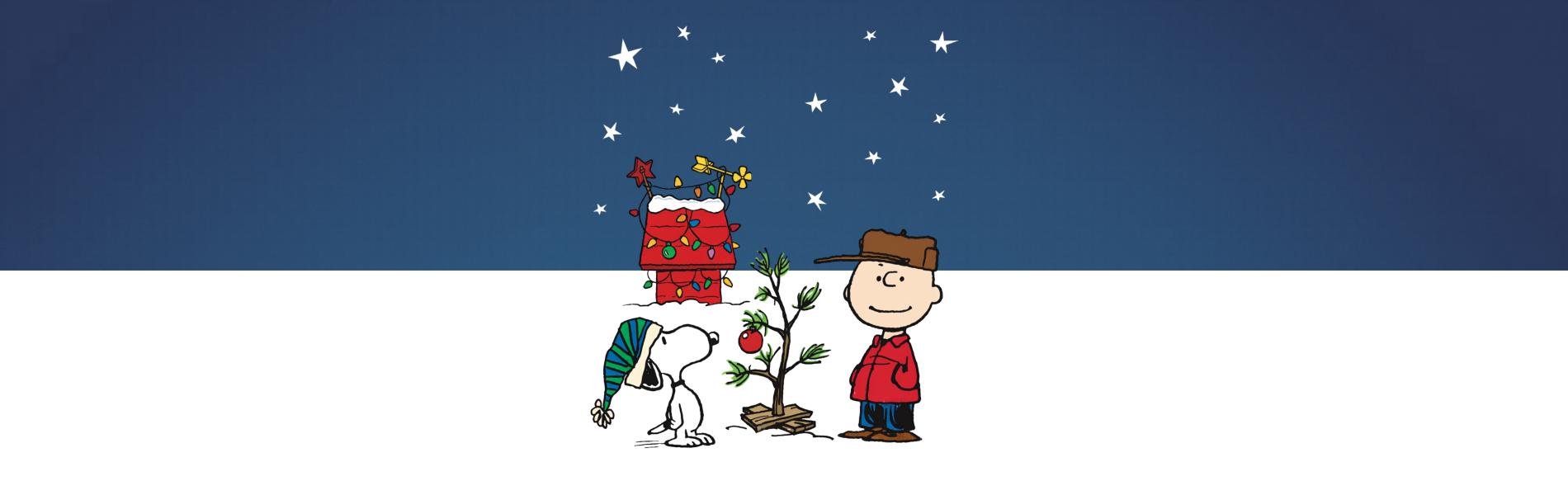 Charlie Brown and Snoopy stand outside on a snowy day.