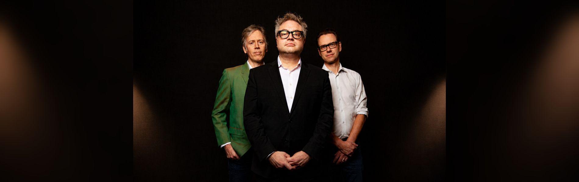 The Steven Page trio pose, facing the camera.