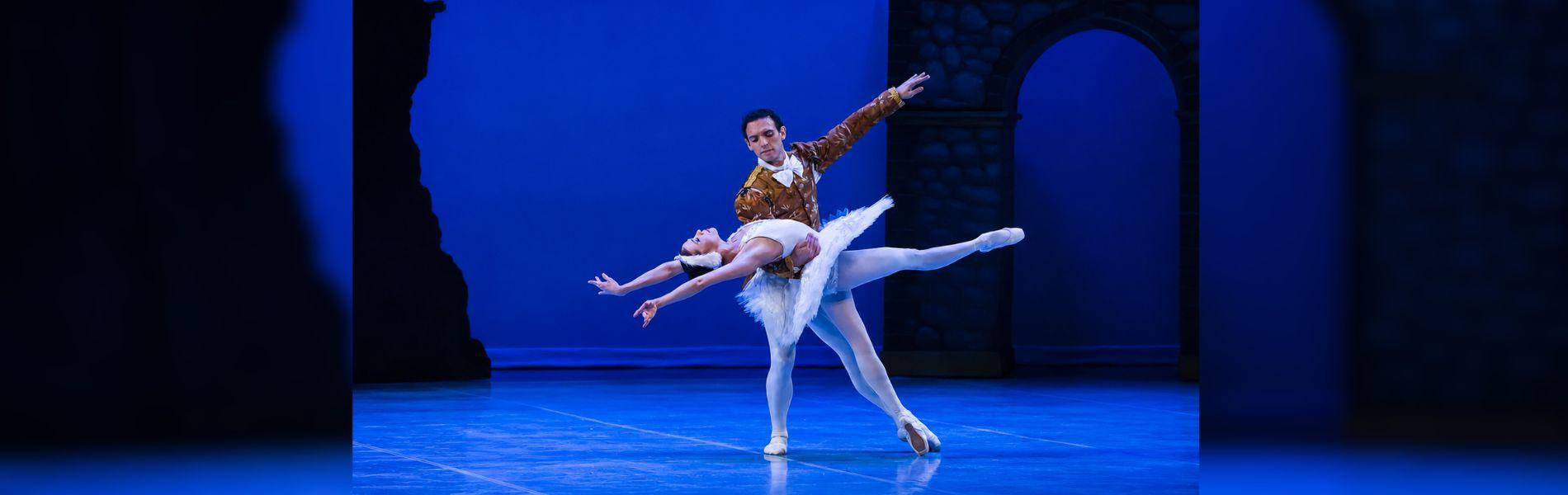 Two dancers strike a pose on stage