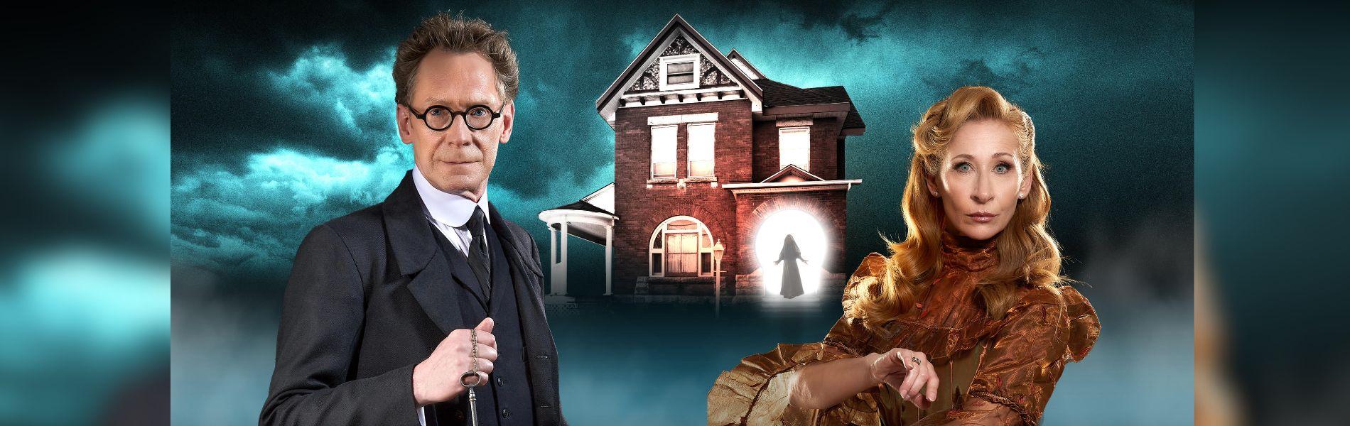 Two magicians stand in front of a mysterious house. 