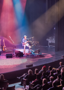 A full audience in the Playhouse with a band on stage