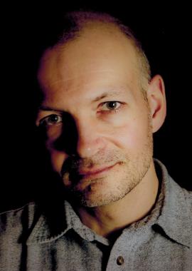 Close up headshot of Len Falkenstein against a black background